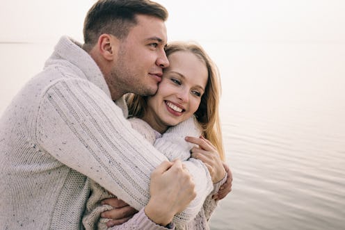 couple hugging on a pier