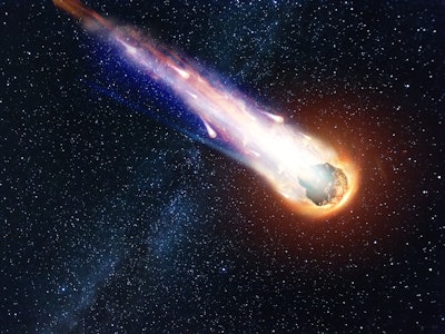 A comet, an asteroid, a meteorite falls to the ground against a starry sky. Attack of the meteorite....