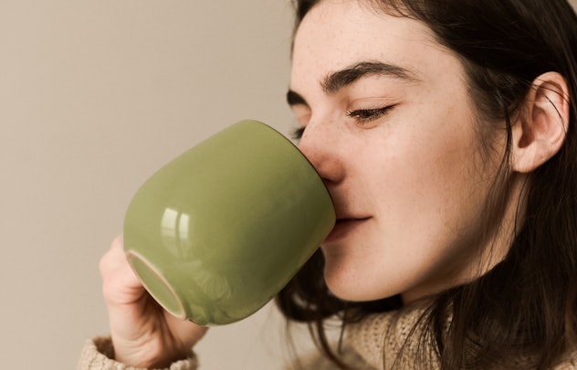 Woman drinks tea from a cup