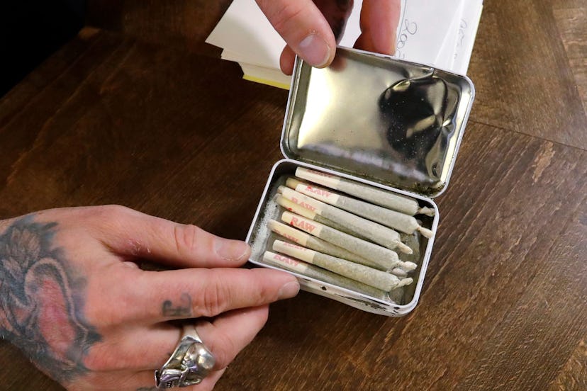 A clerk packs pre-rolled marijuana joints for a customer at the Medicinal Cannabis Dispensary, an un...