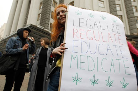 A participant holds a placard during the march.
Participants of the rally advocate the legalisation ...