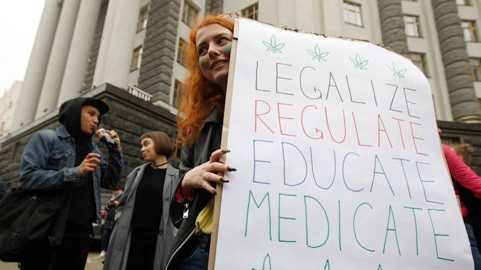 A participant holds a placard during the march.
Participants of the rally advocate the legalisation ...