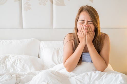 Asia woman are sick on the bed just a wake up on morning time,