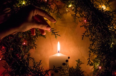 Warm christmas candle with garlands in a wreath	