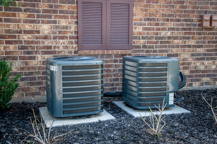 Air conditioning and heating units outside a brick building