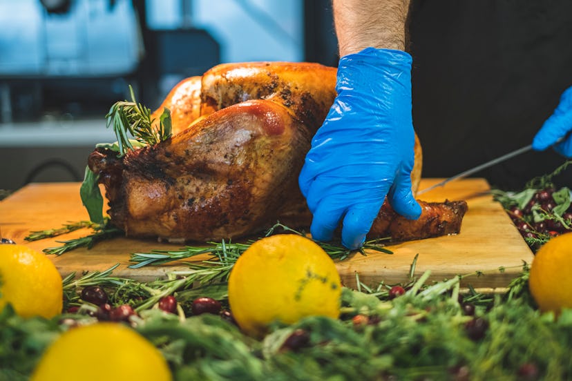 Person carving roasted turkey for Thanksgiving