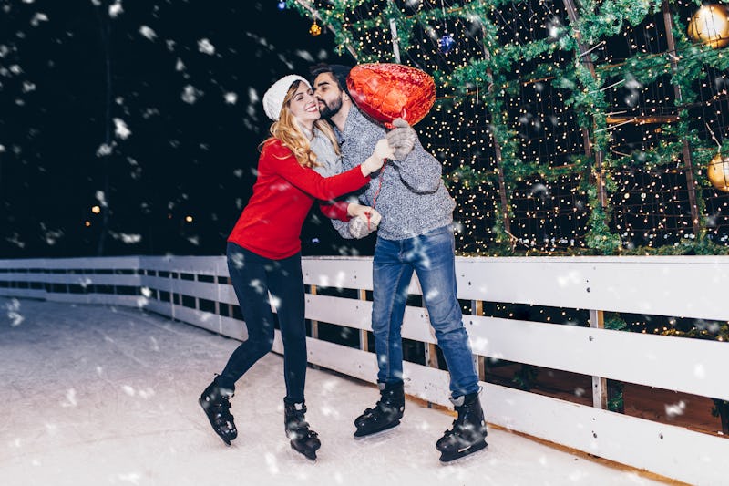 Happy romantic young couple enjoying together in ice skating.