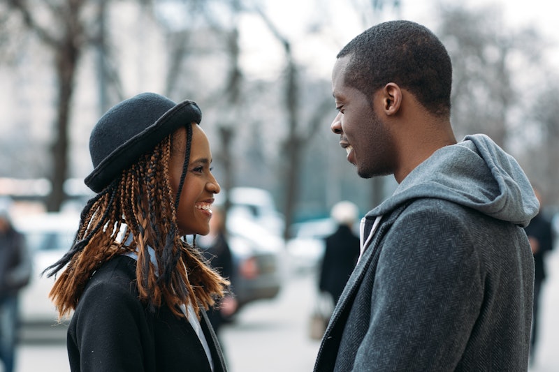 Happy young couple. Good news for black male. Joyful African American first date, stylish people on ...