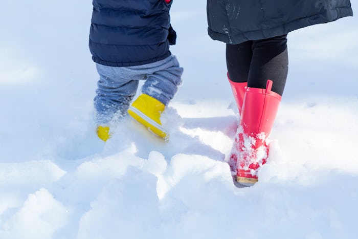 Experts say wearing your own boots can convince your toddler to keep theirs on.