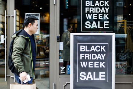 A person walks past signs for Black Friday related sales in New York, New York, USA, 25 November 201...