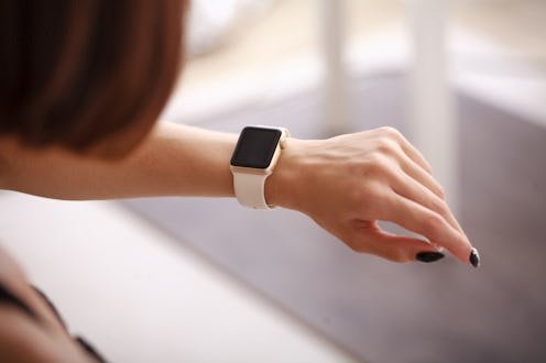 Woman using her smartwatch. Woman hand with smartwatch