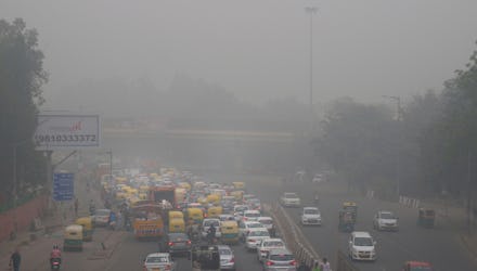 Vehicles wait for a signal at a crossing as the city enveloped in smog in New Delhi, India. Authorit...
