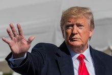 President Donald Trump waves after speaking to reporters upon arrival at the White House in Washingt...