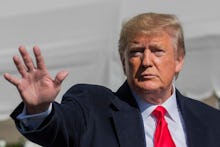 President Donald Trump waves after speaking to reporters upon arrival at the White House in Washingt...