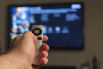 Holding hand on remote control