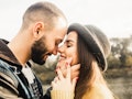 Lovely couple. Girl in hat close eyes. Boyfriend hugging her face. Romantic day. Outdoor. Cozy love....