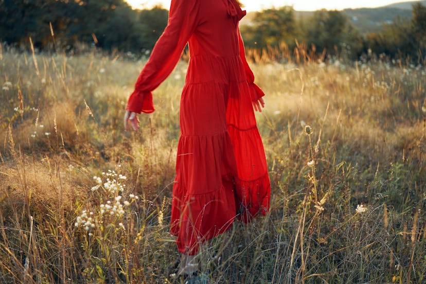 woman in summer dress walks in nature
