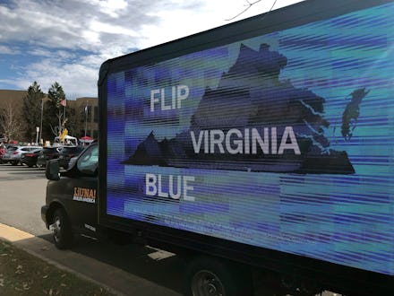 A mobile billboard urges voters to cast ballots for Democrats outside Centreville High School in Cli...
