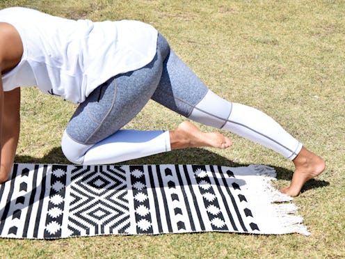 woman yoga pose outdoors exercising
on mat