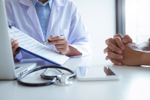 Medical Doctor consultant with patient in clinic office or hospital.