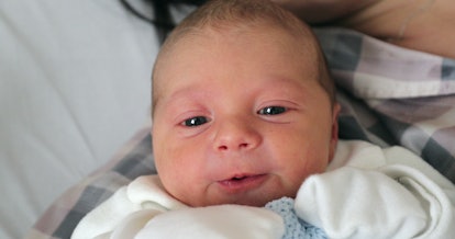 Baby newborn with mom layed in hospital bed