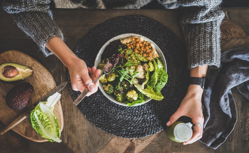 Healthy dinner, lunch setting. Flat-lay of vegan superbowl or Buddha bowl with hummus, vegetable, sa...