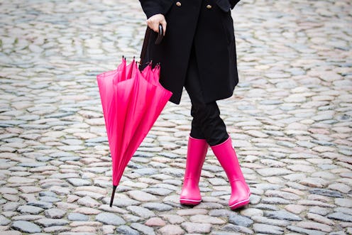 Woman with pink umbrella and pink rubber boots