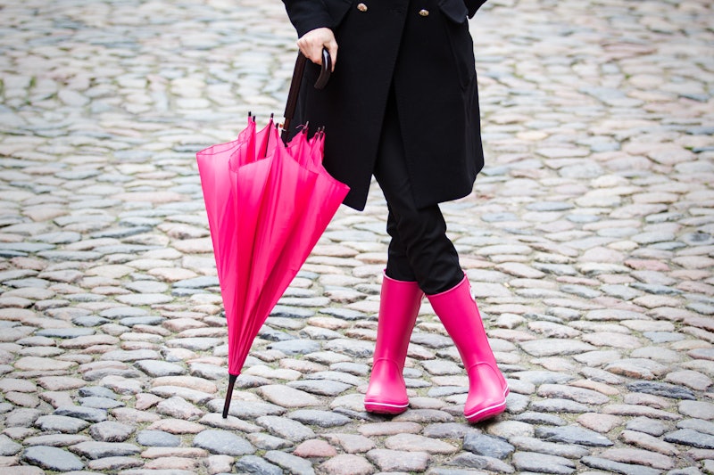 Woman with pink umbrella and pink rubber boots
