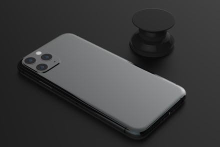 New Iphone 11 Pro Max. Smartphone mock with pop socket isolated on black background. Back side. Conc...