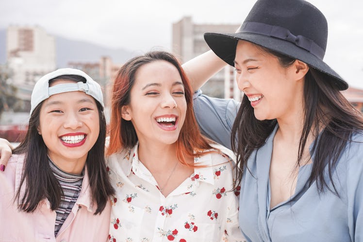 Asian women friends having fun outdoor - Happy trendy girls laughing together - Millennial generatio...