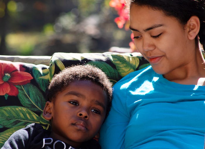 Brother and sister spending time together in yard.