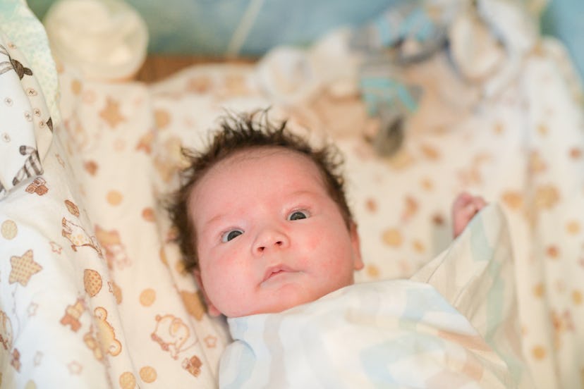 Mother rubs baby after bathing. the boy smiles and feels happy after taking a bath. mother dries and...