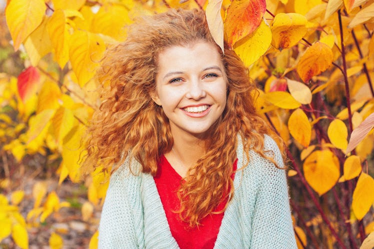 
beautiful red-haired girl in the autumn park