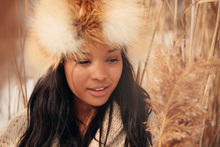 Portrait of one young woman in a meadow in winter