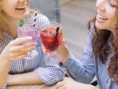 Drinking may affect the periods of these two women clinking glasses very differently 