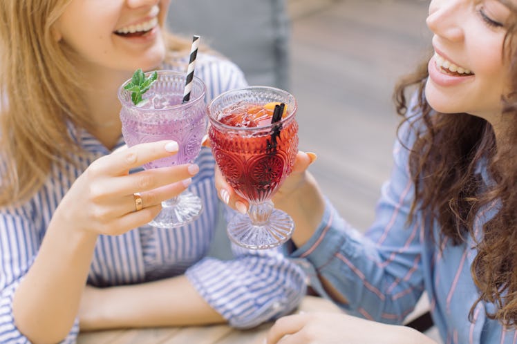 Drinking may affect the periods of these two women clinking glasses very differently