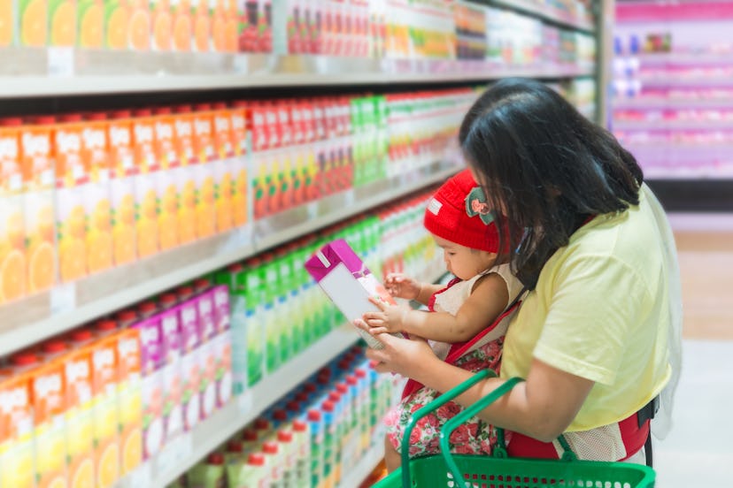 Mother and baby shopping in the supermarket,Thai woman has a daugther