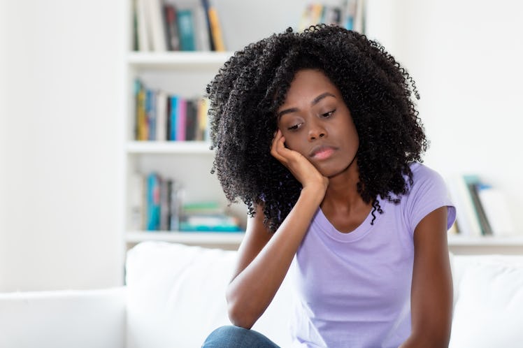 Sad and frustrated african american woman indoors at home