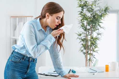 Woman ill with flu working in office