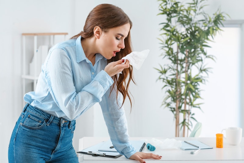 Woman ill with flu working in office