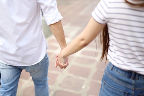 Couple holding hands and walking in the temple