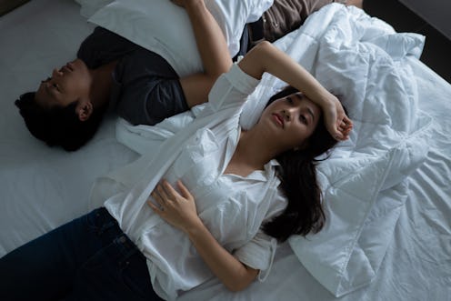 Asian couples are very stressed. they are in bed thinking