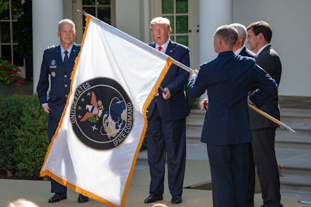 The flag of the United States Space Command is displayed during the ceremony where United States Pre...