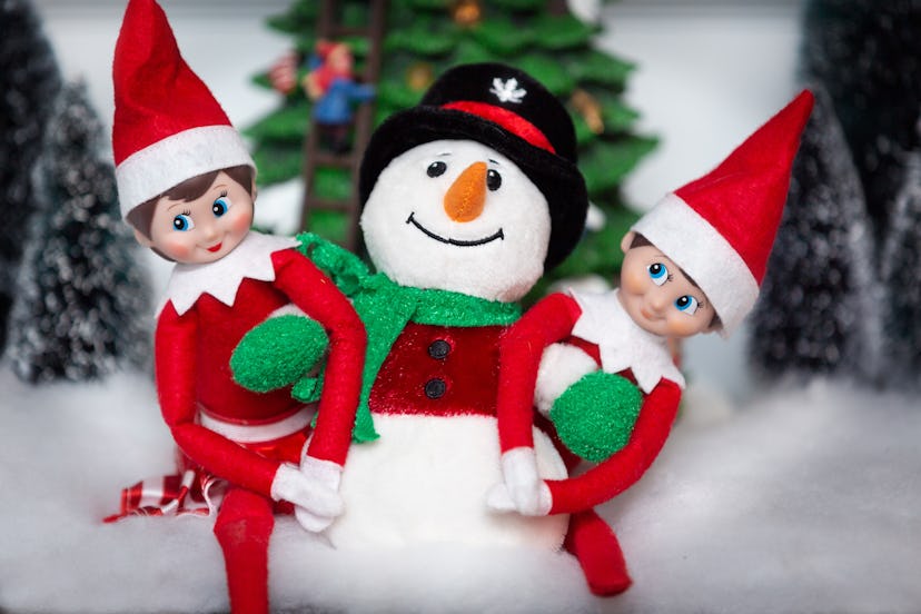 Elf on the shelf with a snowman.