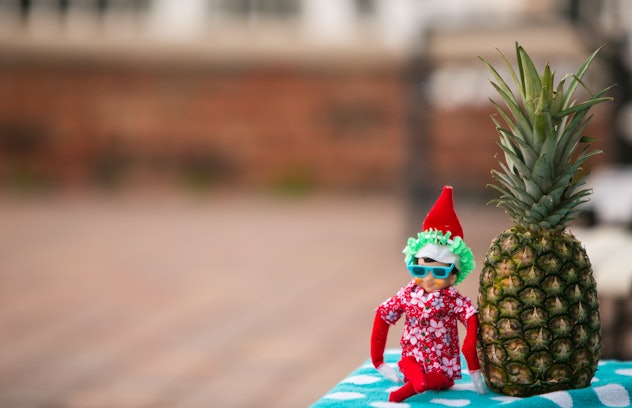 Christmas Elf lounging by the swimming pool celebrating time off. Christmas retail sales marketing c...