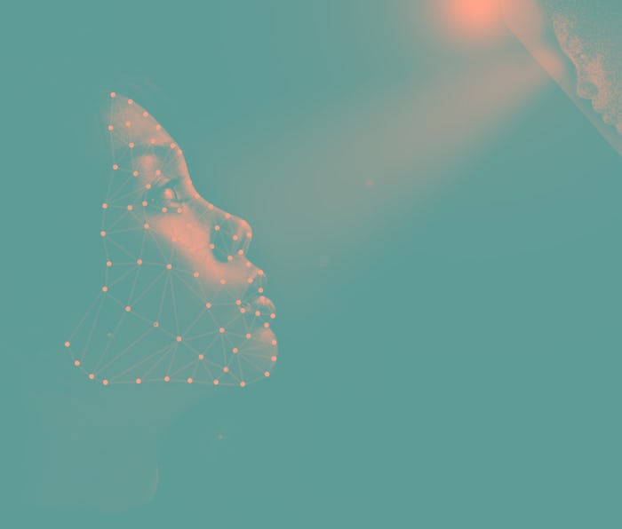 Girl looking up for facial recognition towards mobile phone in which her face has been digitized, wi...