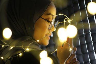 Portraiture of Asian women wearing hijab with fairy light concept.