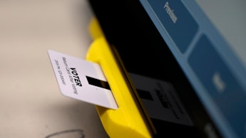 An electronic card with ballot information is seen inserted in a voting machine in Dallas, Ga. While...