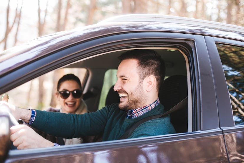 Couple driving in a car in their hometown to see all the old haunts