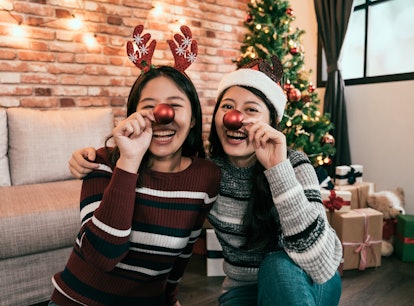 Sisters wearing red noses at Christmas to post on Instagram with reindeer puns and reindeer quotes.